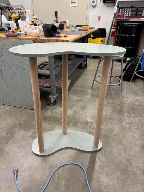 A standing-height Bean Table, with a recycled-HDPE top and base on wooden legs.
