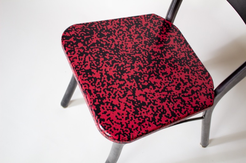 Seat of a Level 7 chair: pressed recycled HDPE in a red-and-black marble, finished to a gloss.