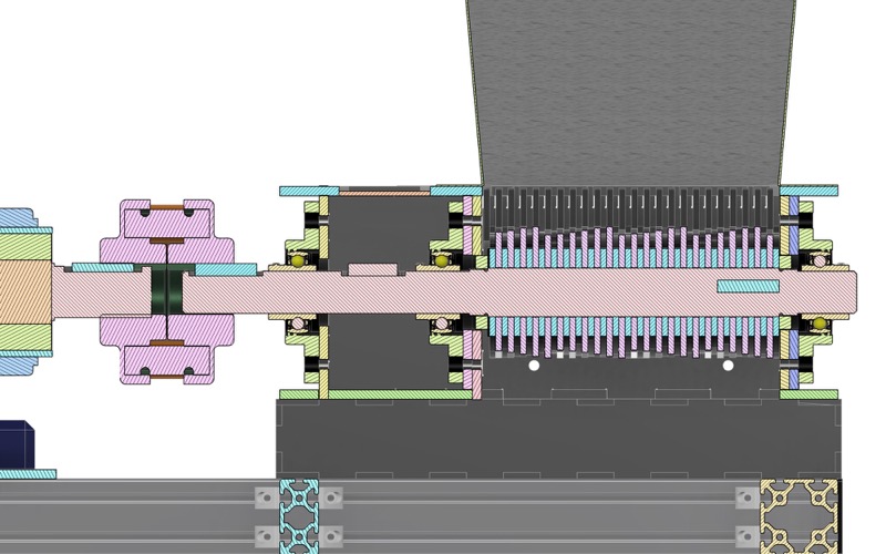 Section along the blade shaft: jaw coupling, keyed shaft, UCFL 209 flange bearings on both walls of the box, and the interleaved blade stack under the hopper.