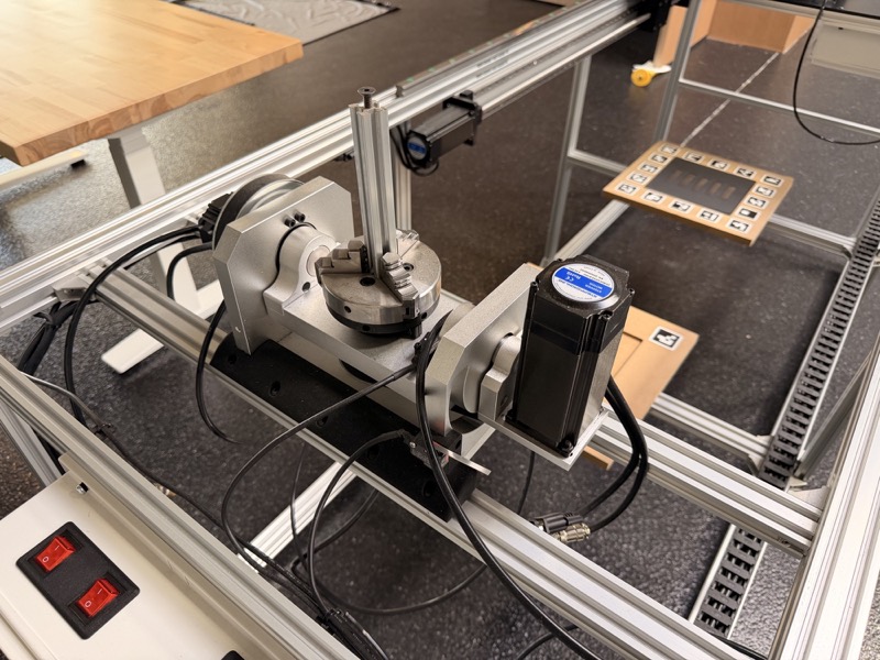 The tilt-rotary stage with the target board off, showing the three-jaw chuck on the rotary table in its tilting cradle.